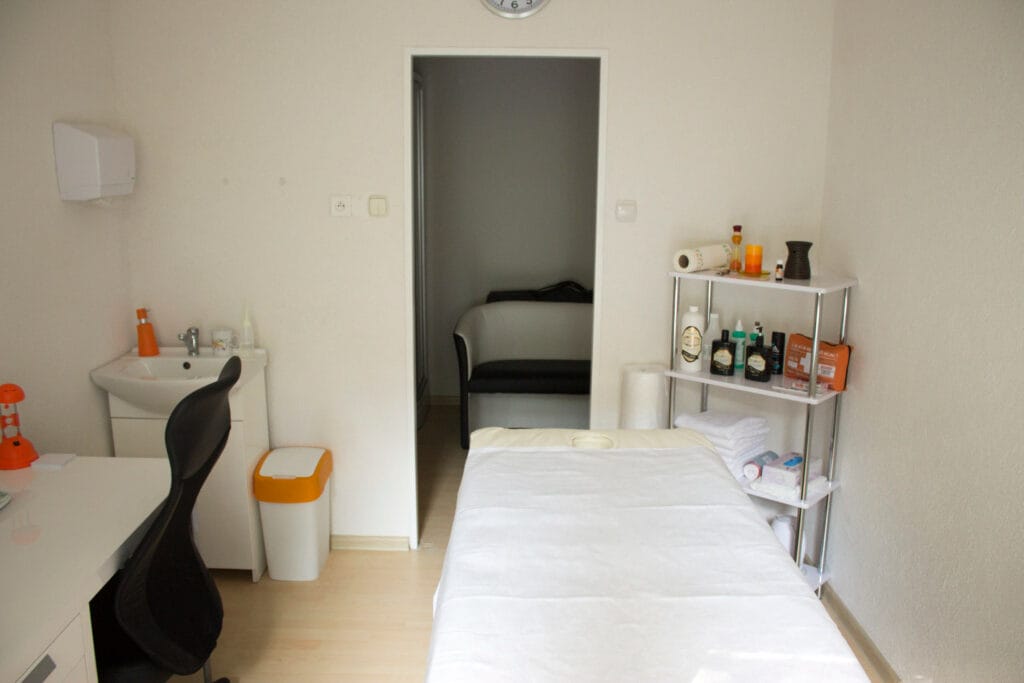 Malá miestnosť s posteľou a písacím stolom v Masážnom salóne MM Banská Bystrica.